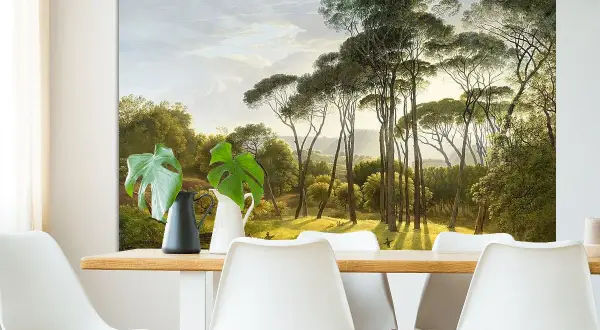 Een schilderij van Hendrik Voogd toont een zonnig landschap met hoge pijnbomen en weelderig groen.