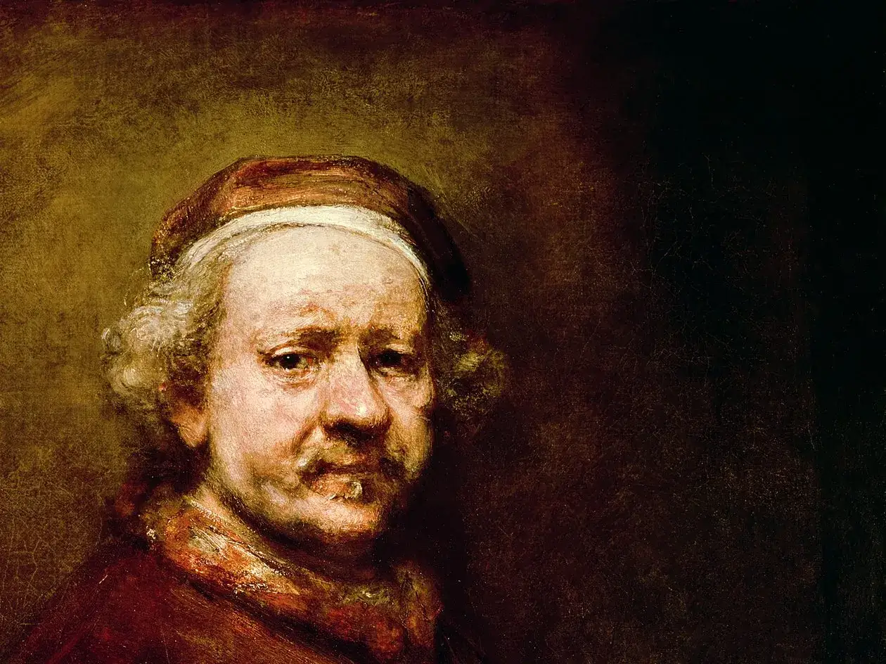 Een oudere Rembrandt, met een baret en rode kleding, kijkt peinzend de kijker aan in dit beroemde Rembrandt zelfportret.